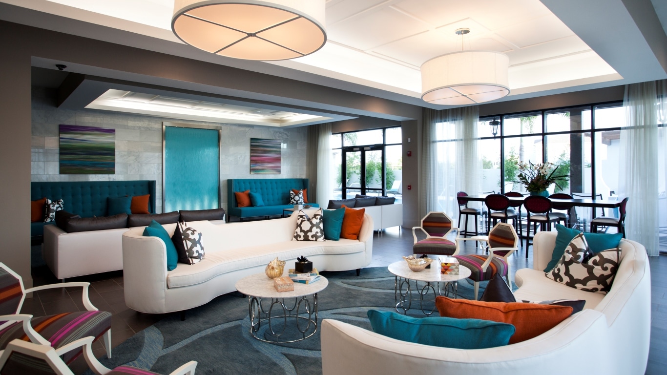 azul resident lounge with colorful social seating, tables, chairs, and modern lighting - jefferson apartment group