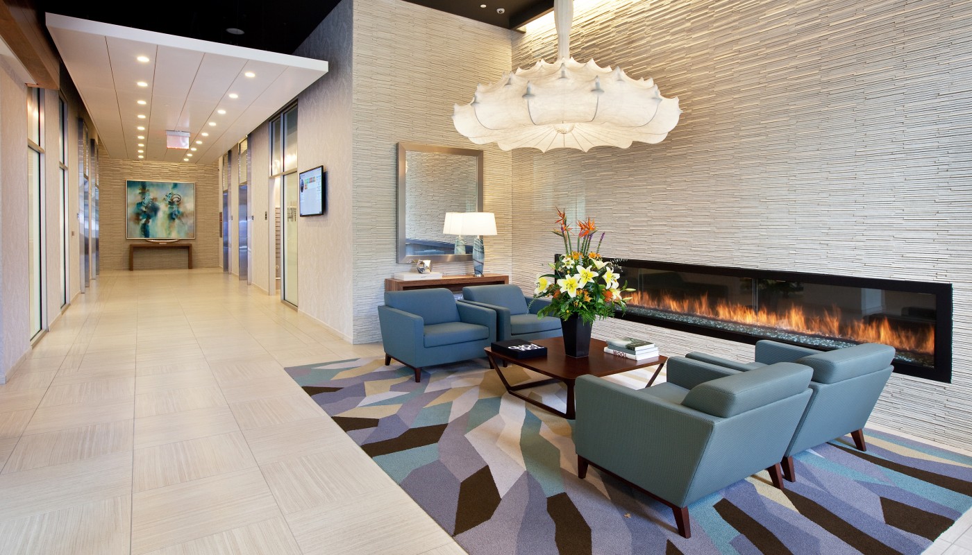 lobby with large fireplace, social seating and modern lighting - jefferson apartment group