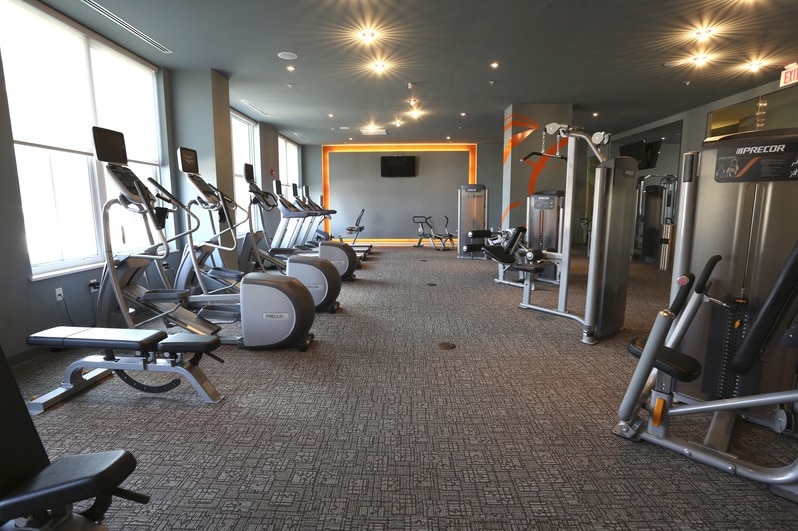 asher fitness center with cardio equipment, strength training machines, flat screen tvs and large windows - jefferson apartment group