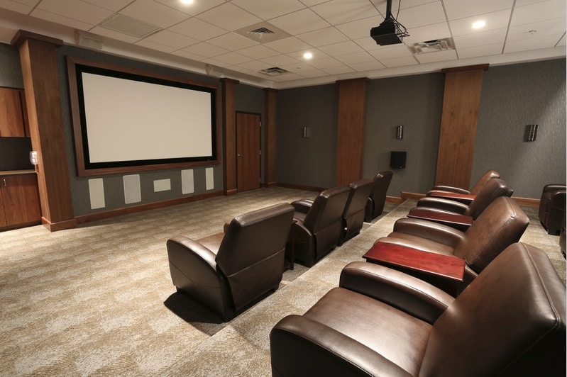 asher media room with large leather chairs, and movie screen - jefferson apartment group