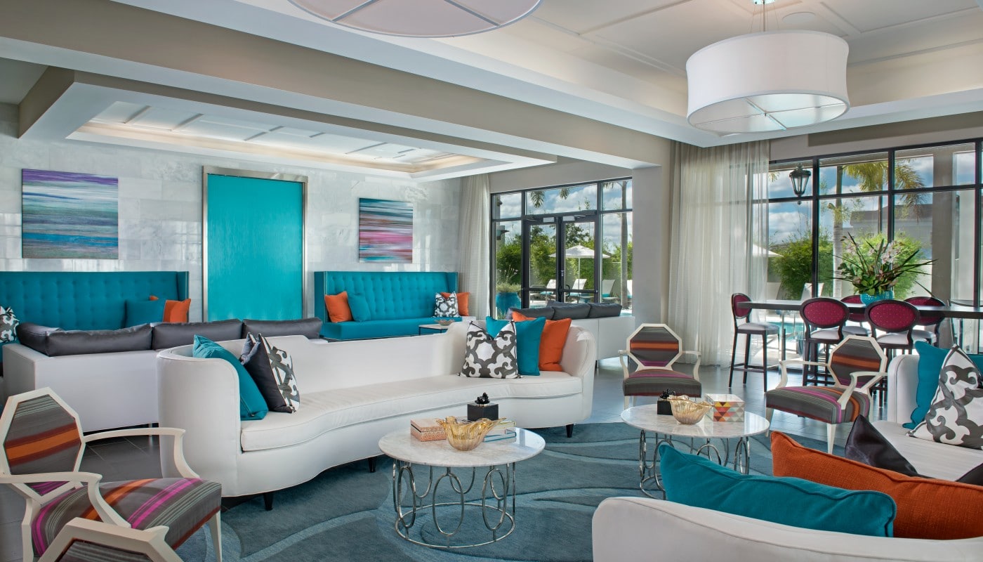 azul resident lounge with social seating, tables, chairs, large windows and modern lighting - jefferson apartment group