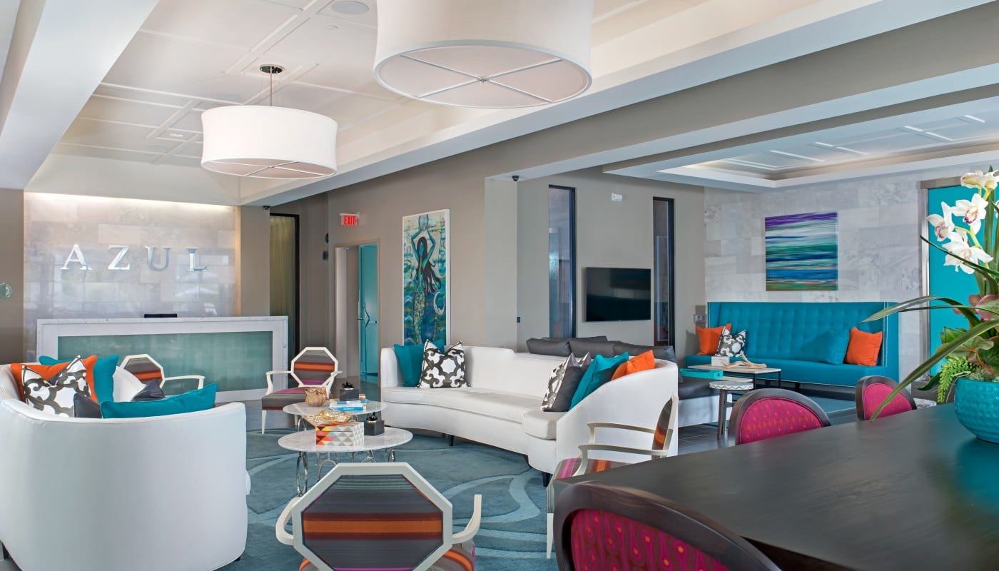 azul lobby with concierge desk, colorful social seating, tables, chairs, and modern lighting - jefferson apartment group