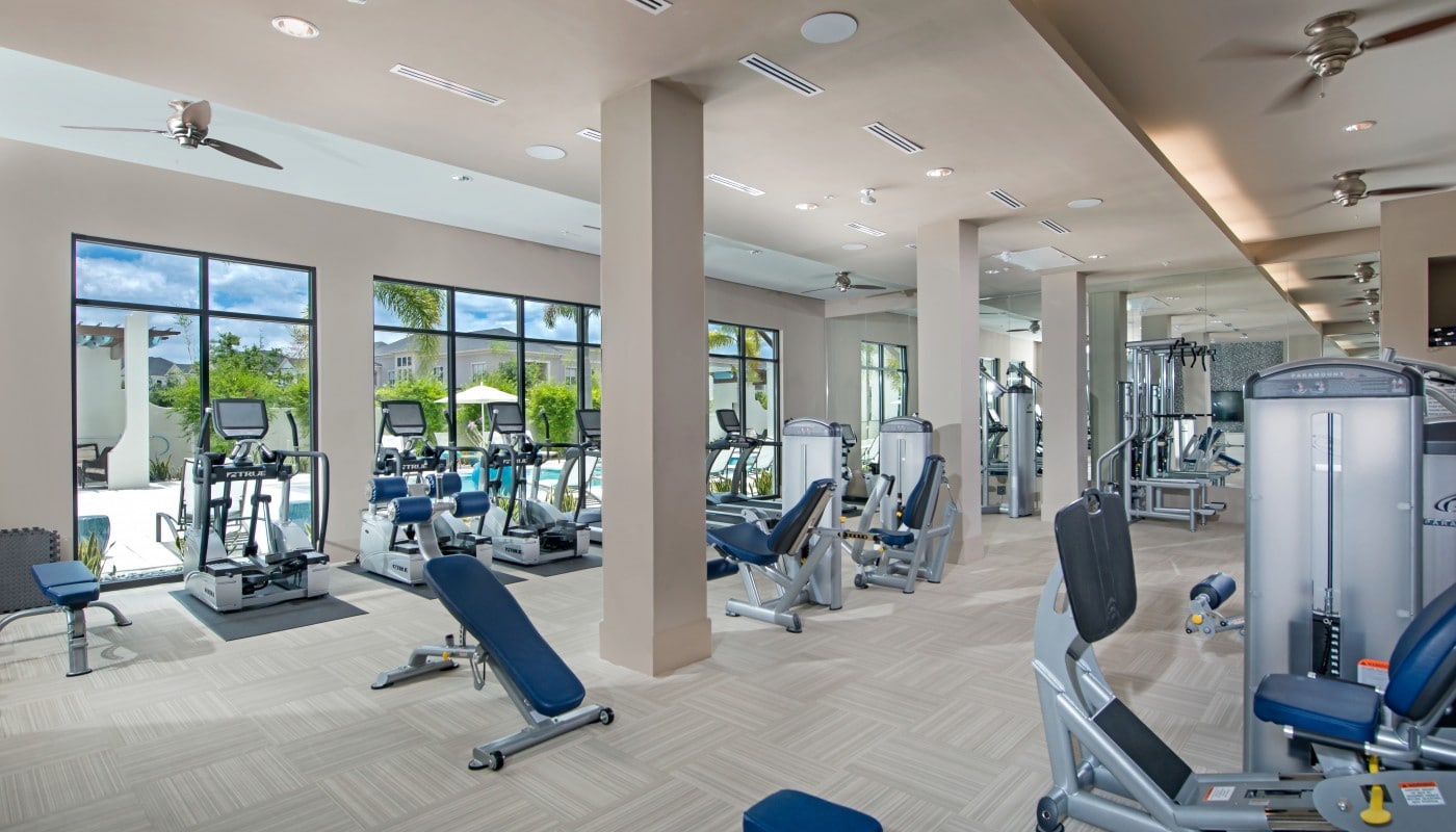 azul fitness center with cardio machines, strength training equipment, ceiling fans, and view of pool - jefferson apartment group