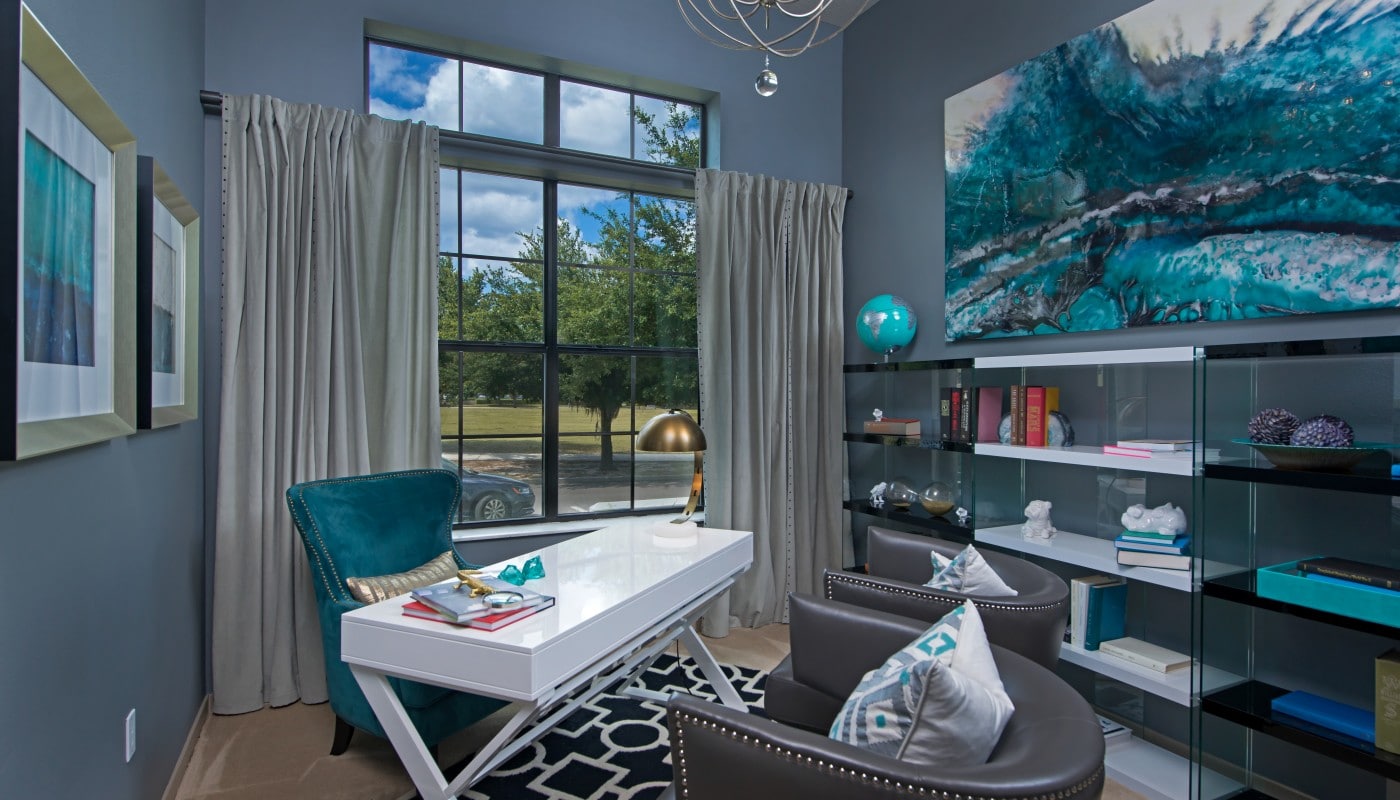 azul den with desk, chairs, shelving, modern artwork and large windows - jefferson apartment group
