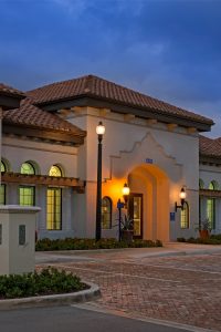 exterior view of jefferson lighthouse place at dusk with palm trees and green landscaping - jefferson apartment group