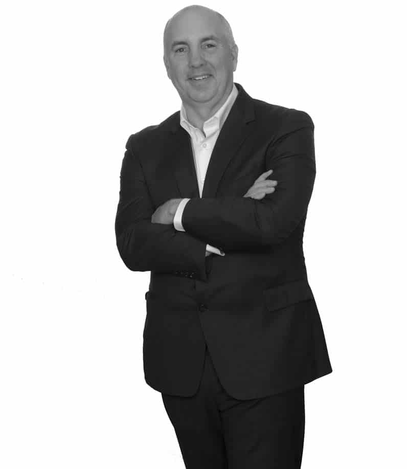 black and white standing photo of greg lamb executive vice president and coo, black and white standing up - jefferson apartment group