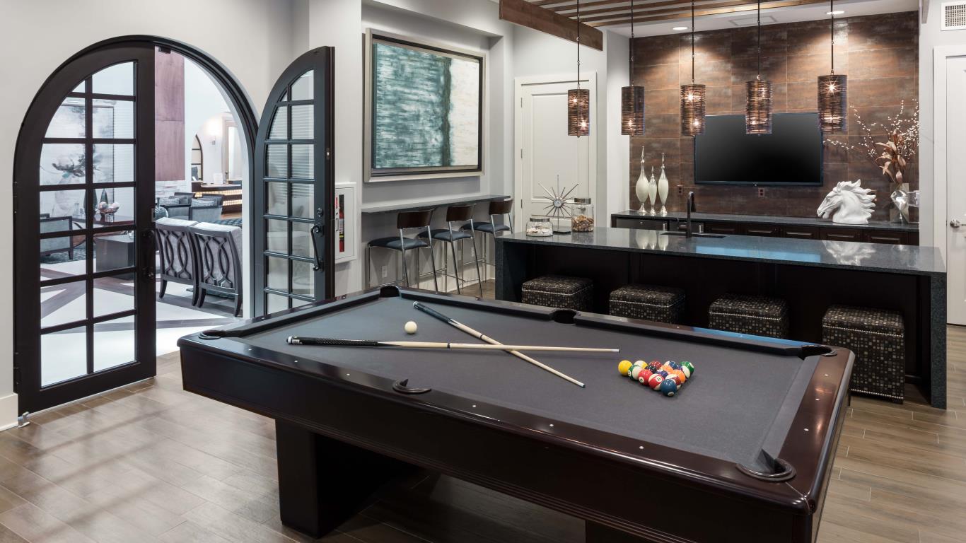 jefferson montera game room with billards. bar seating, modern artwork, and large french doors - jefferson apartment group