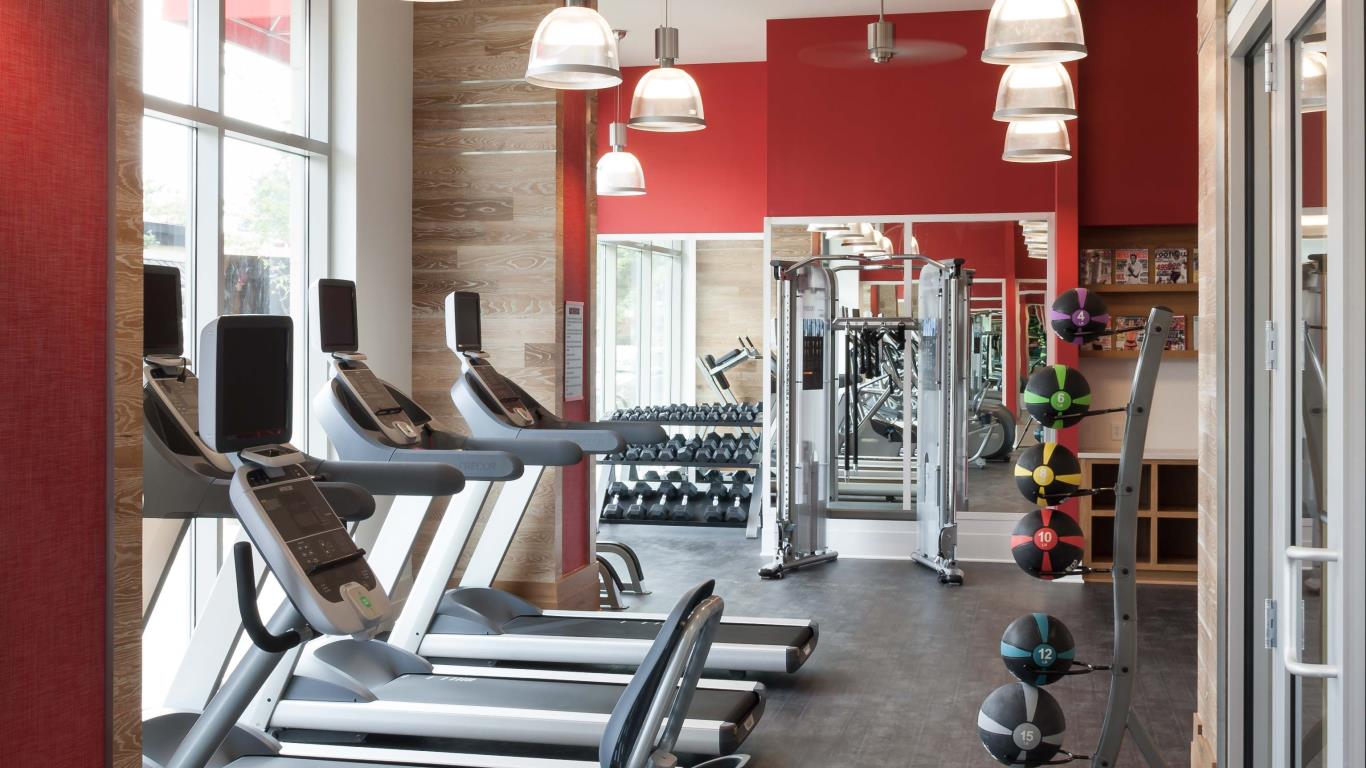 jefferson marketplace fitness center with large windows, exercise balls, strength training machines and cardio equipment - jefferson apartment group