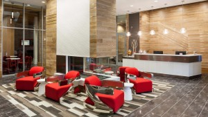 jefferson marketplace lobby with social seating, fireplace, concierge desk and large glass doors - jefferson apartment group
