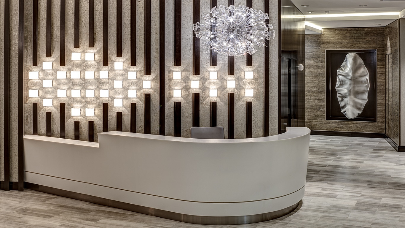 tellus concierge desk with modern arwork and lighting - jefferson apartment group