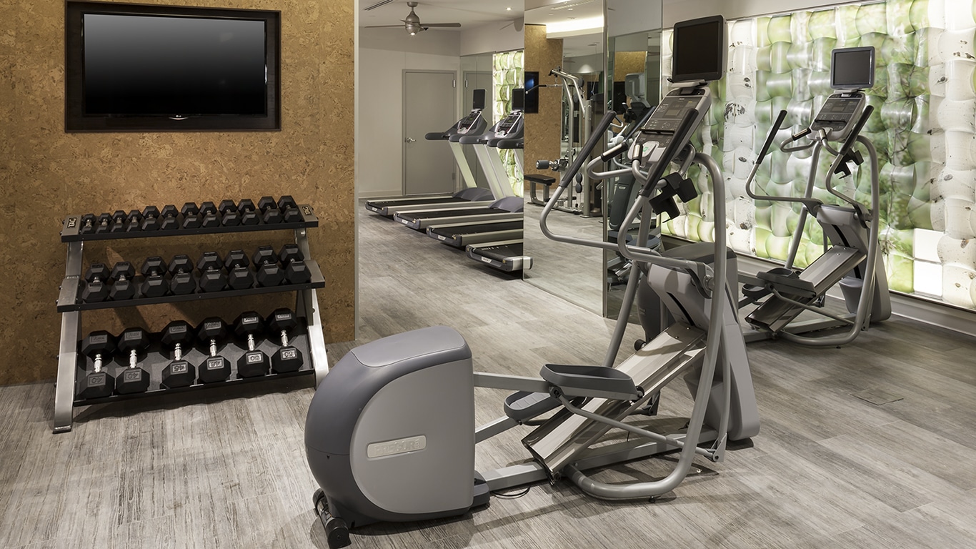 tellus fitness center with cardio machines. free weights, and flat screen tv - jefferson apartment group