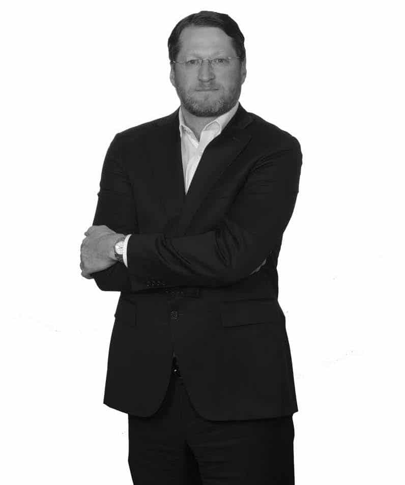 black and white image of james duncan, standing up executive vice president and cfo - jefferson apartment group