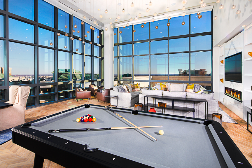 sky lounge with large windows and billiards - j sol apartments