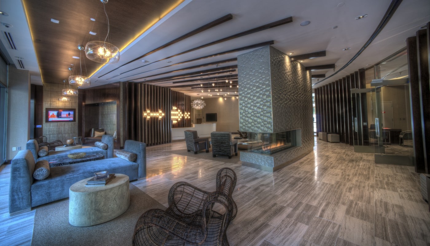 tellus lobby with fireplace, social seating, modern lighting, concierge desk, flat screen televisions and modern artwork - jefferson apartment group