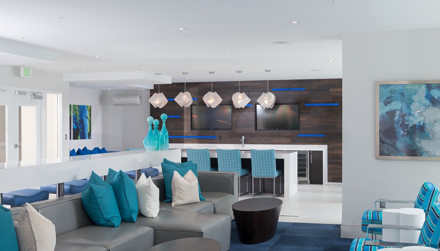 resident lounge with bar seating, demonstration kitchen, social seating, modern lighting and modern artwork - jefferson apartment group