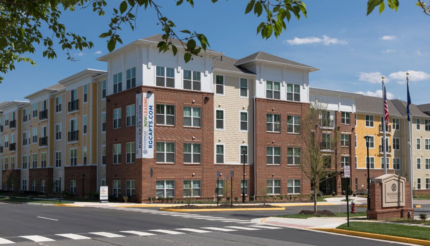 exterior of 4 story apartment building called residences at government center in fairfax va