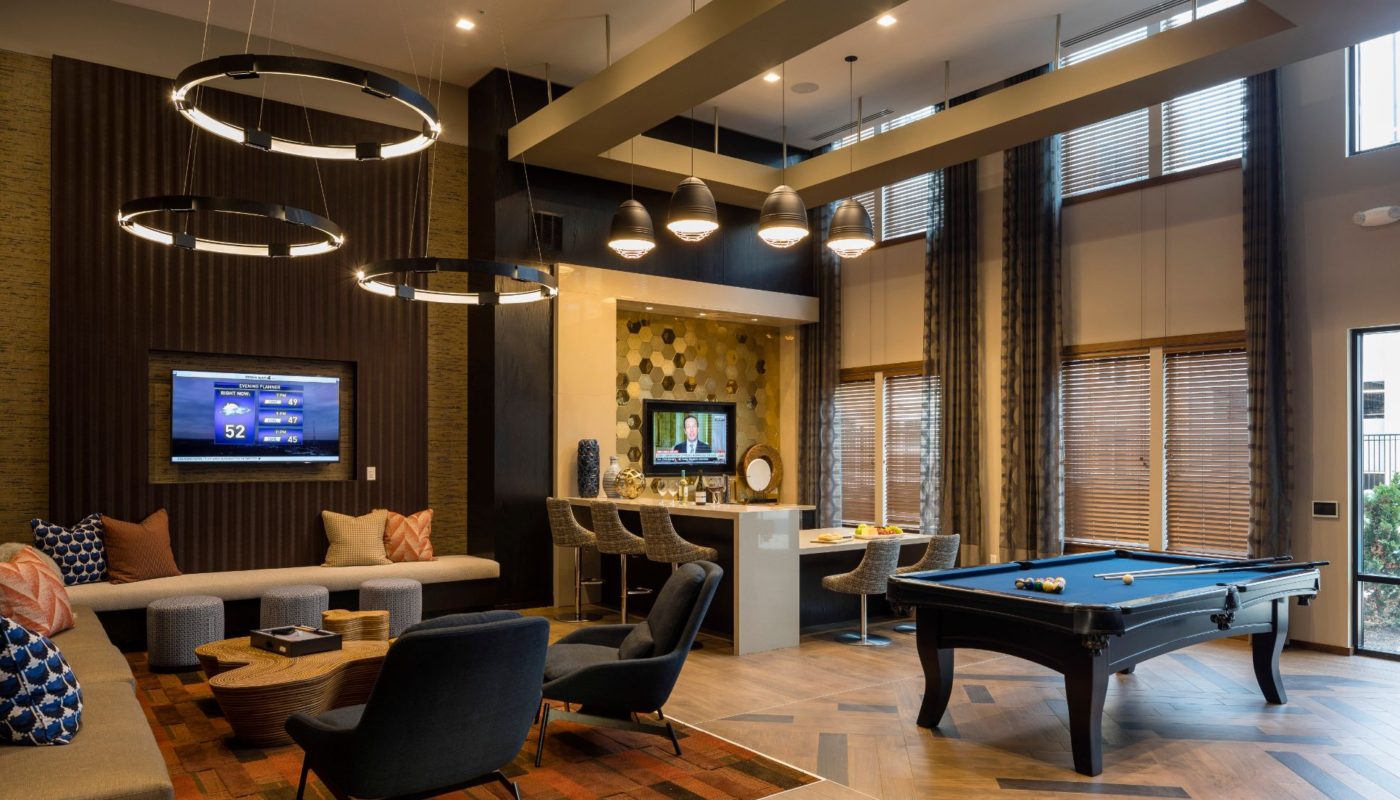 game room with social seating, billiards table and flat screen tvs at residences at government center in fairfax va