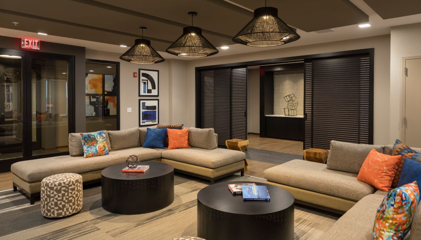 lounge at residences at government center with social seating, tables, decorative lighting and storage cabinets