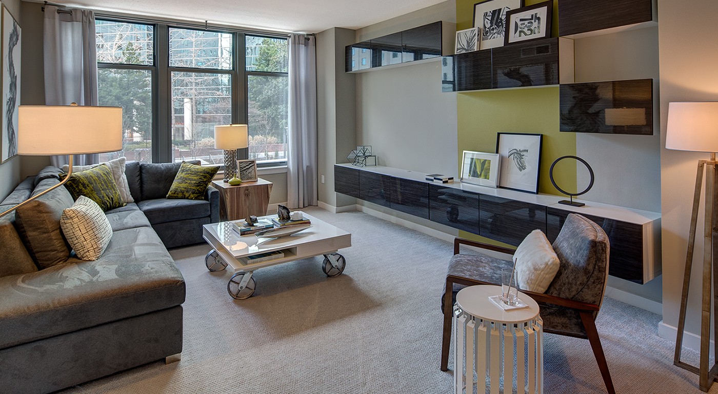 tellus living area with sectional sofa, coffee table, decorative credenza, and large window - jefferson apartment group