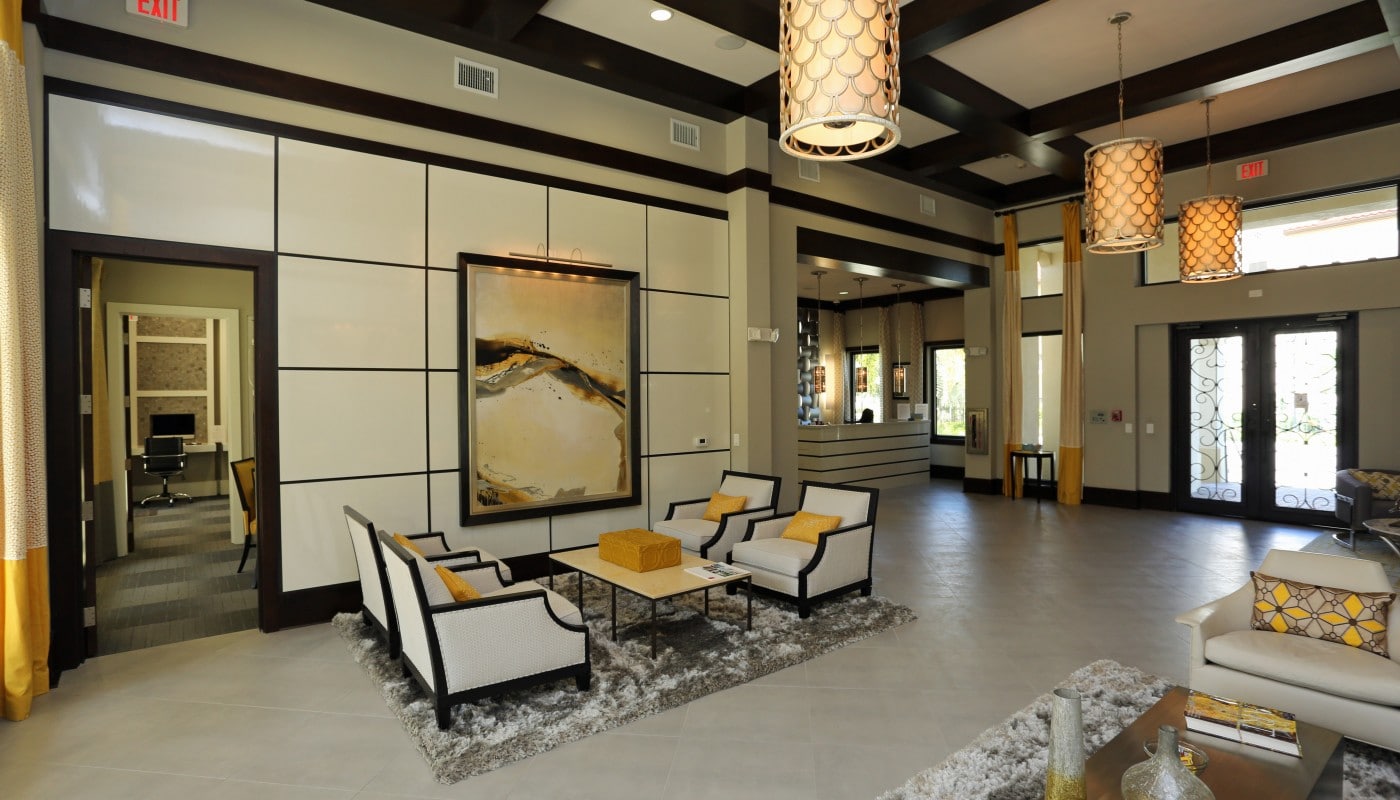 jefferson palm beach lobby with social seating, modern artwork and view of business center - jefferson apartment group