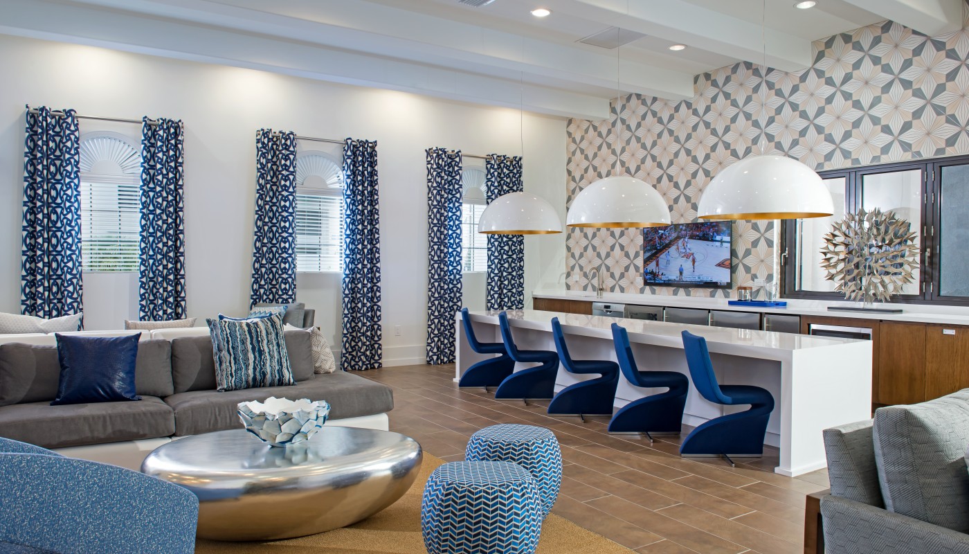 lighthouse point club room with bar seating with demonstration kitchen, sofas, social seating and modern artwork - jefferson apartment group
