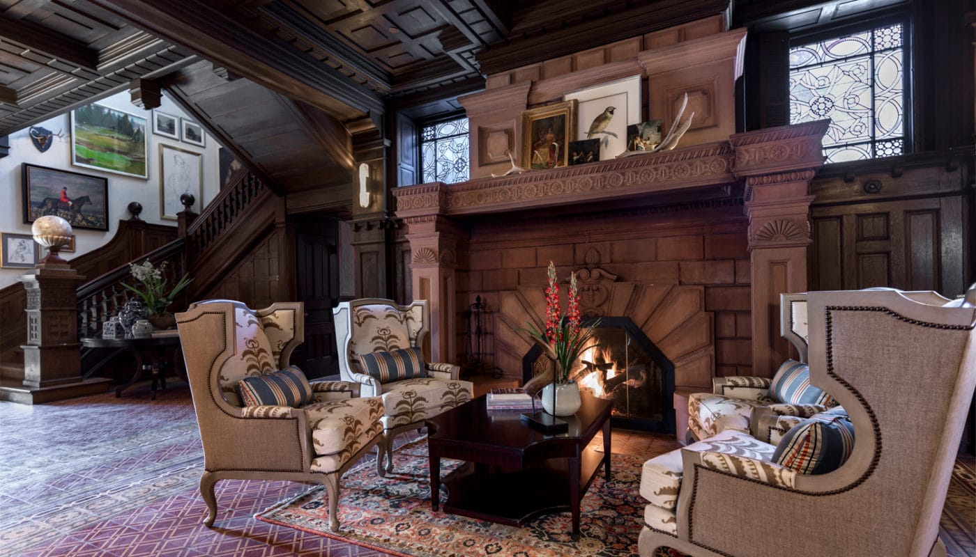 maybrook mansion grand staircase and parlor with social seating and fireplace - jefferson apartment group