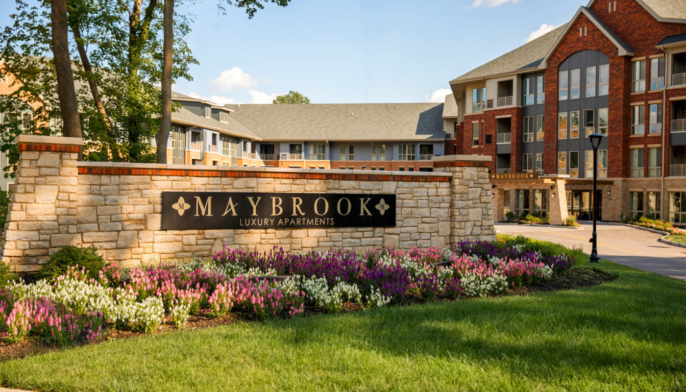 maybrook exterior and view of monument sign with green landscaping and flowers - jefferson apartment group