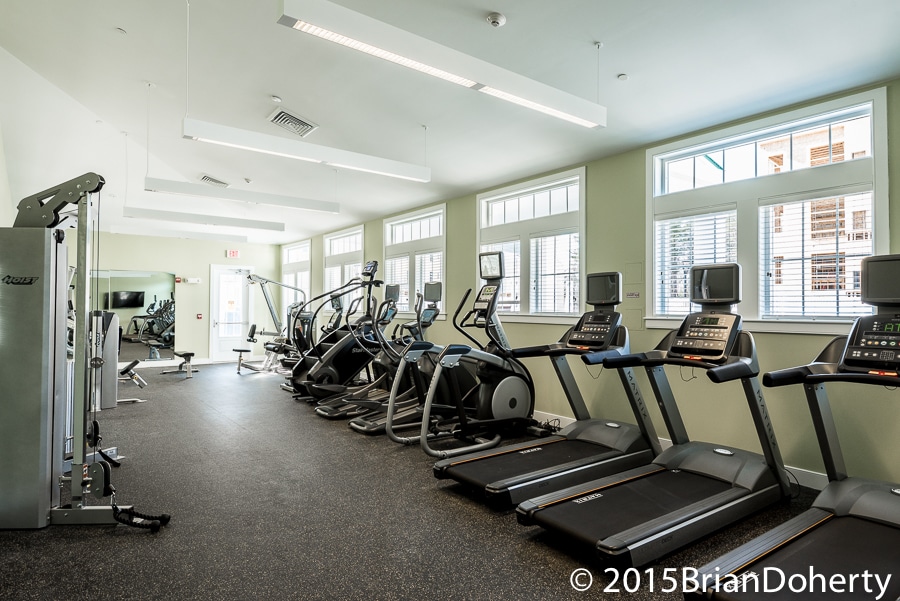 one upland fitness center with cardio machines, strength training equipment, large windows and flat screen tv - jefferson apartment group