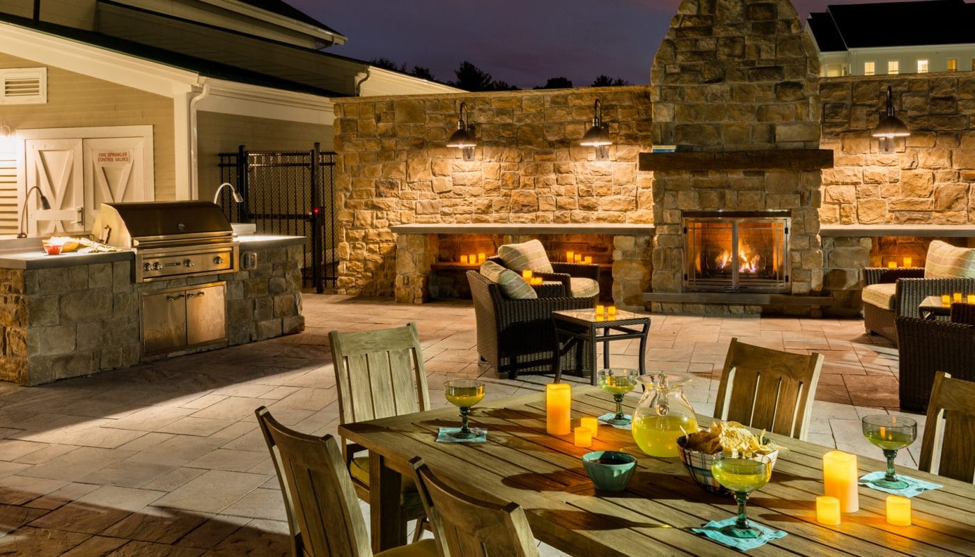 one upland outdoor living area with grilling stations, fireplace, dining tables, and social seating - jefferson apartment group