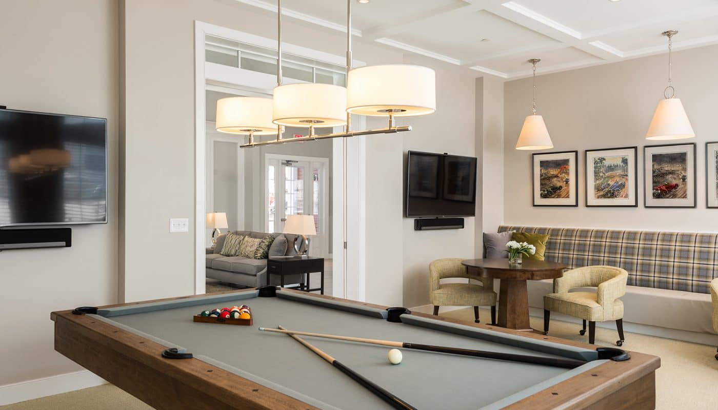 one upland game room with billiards table, social seating, cocktail tables, and flat screen tv - jefferson apartment group