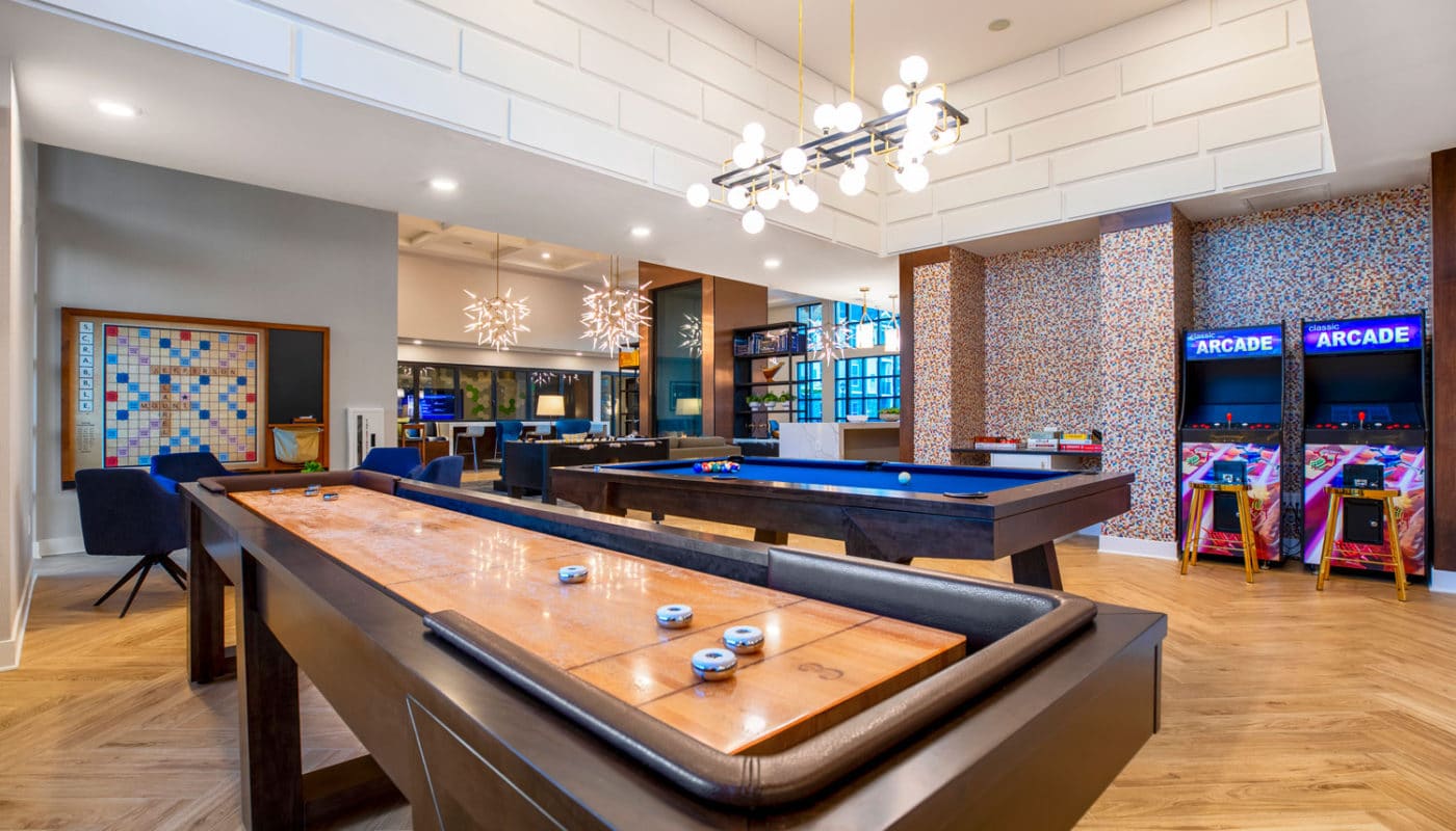 jefferson mount laurel large game room with shuffleboard, pool table, scrabble and arcade games - jefferson apartment group