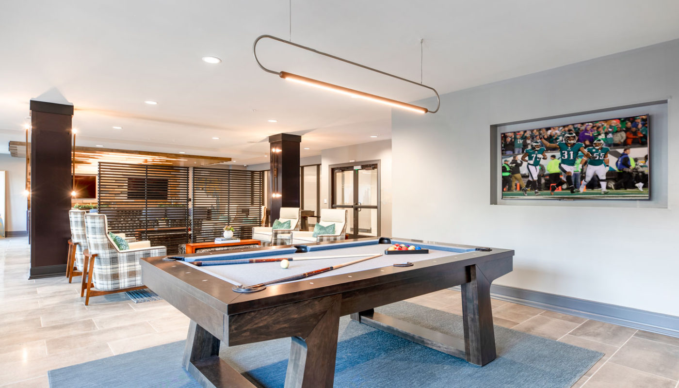 j creekside clubroom with billiards, flat screen tv, social seating and modern lighting - jefferson apartment group