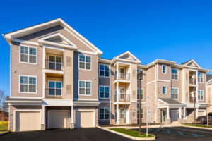 jefferson mount laurel exterior showing three story building with balconies and private garages - jefferson apartment group