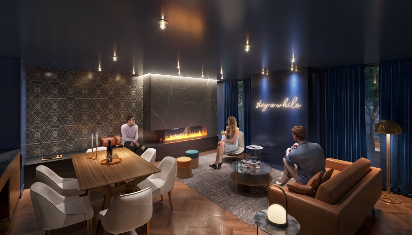 people socializing in the social lounge with social seating, dining table and fireplace
