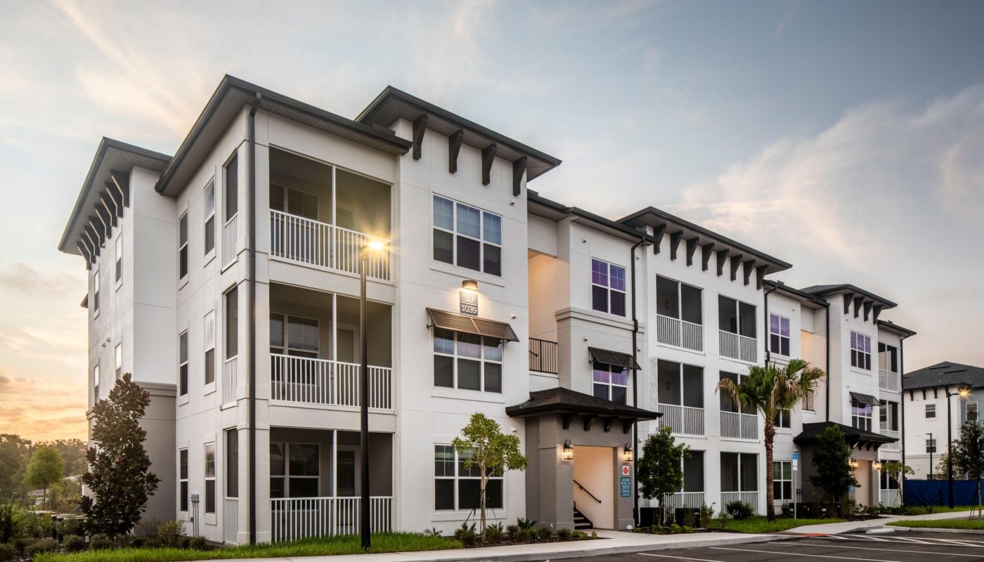 exterior of 3 story apartment building with screened in balconies at jefferson lake howell luxury apartments in Casselberry