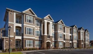 exterior of 3 story apartment building with stone accents at jefferson somerset park apartments in mount laurel NJ