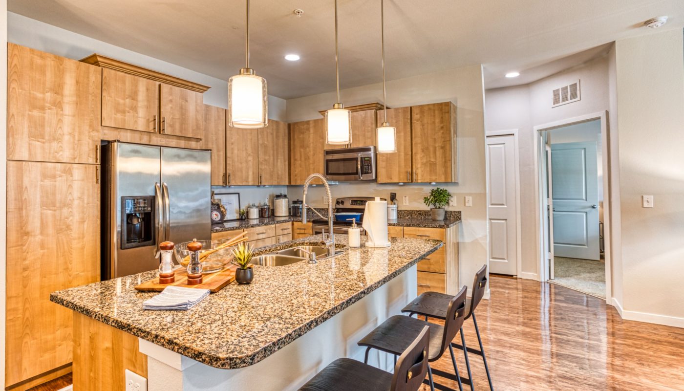 kitchen with granite counters and stainless steel appliances at sea isle luxury orlando apartments