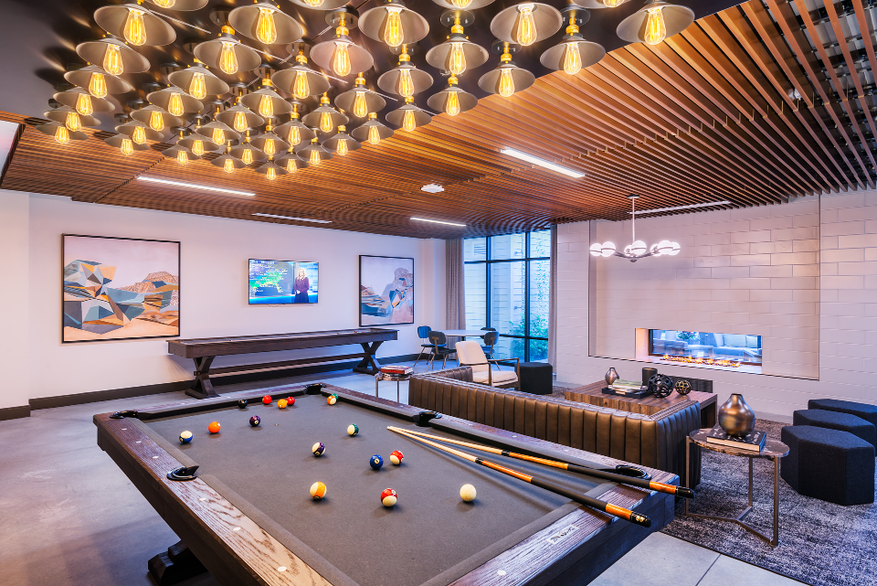 billiards and lounge with fireplace - atelier apartments glenmont metro