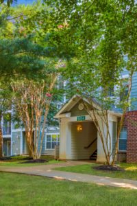building exterior with trees daytime J Harbor Park apartments reston, VA