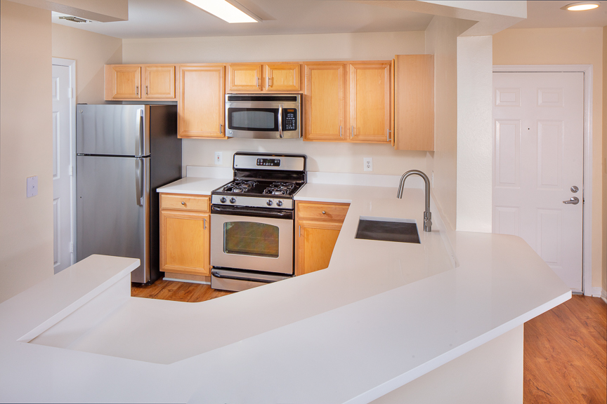 kitchen with plank flooring and stainless steel appliances - j harbor park apartments in reston