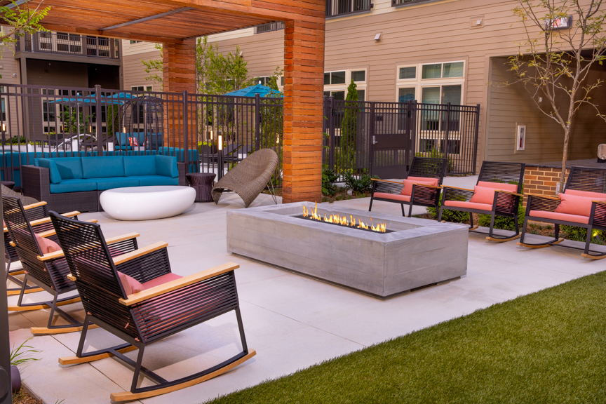 courtyard with fire pit and rocking chairs - South Alex Apartments