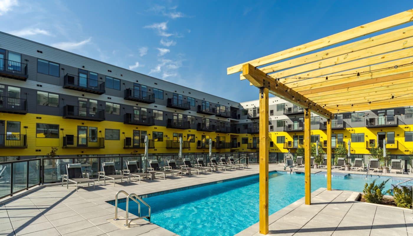 pool with lounge chairs next to building dusk Rivermark Northern Liberties waterfront apartments Philadelphia PA