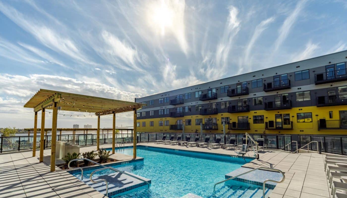 pool with lounge chairs next to building dusk Rivermark Northern Liberties waterfront apartments Philadelphia PA