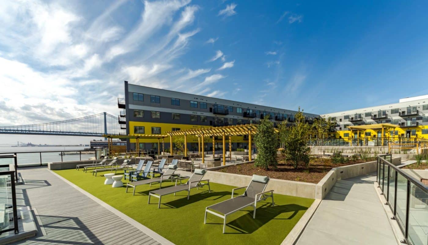 building exterior with courtyard sundeck space with lounge chairs Rivermark Northern Liberties waterfront apartments Philadelphia PA