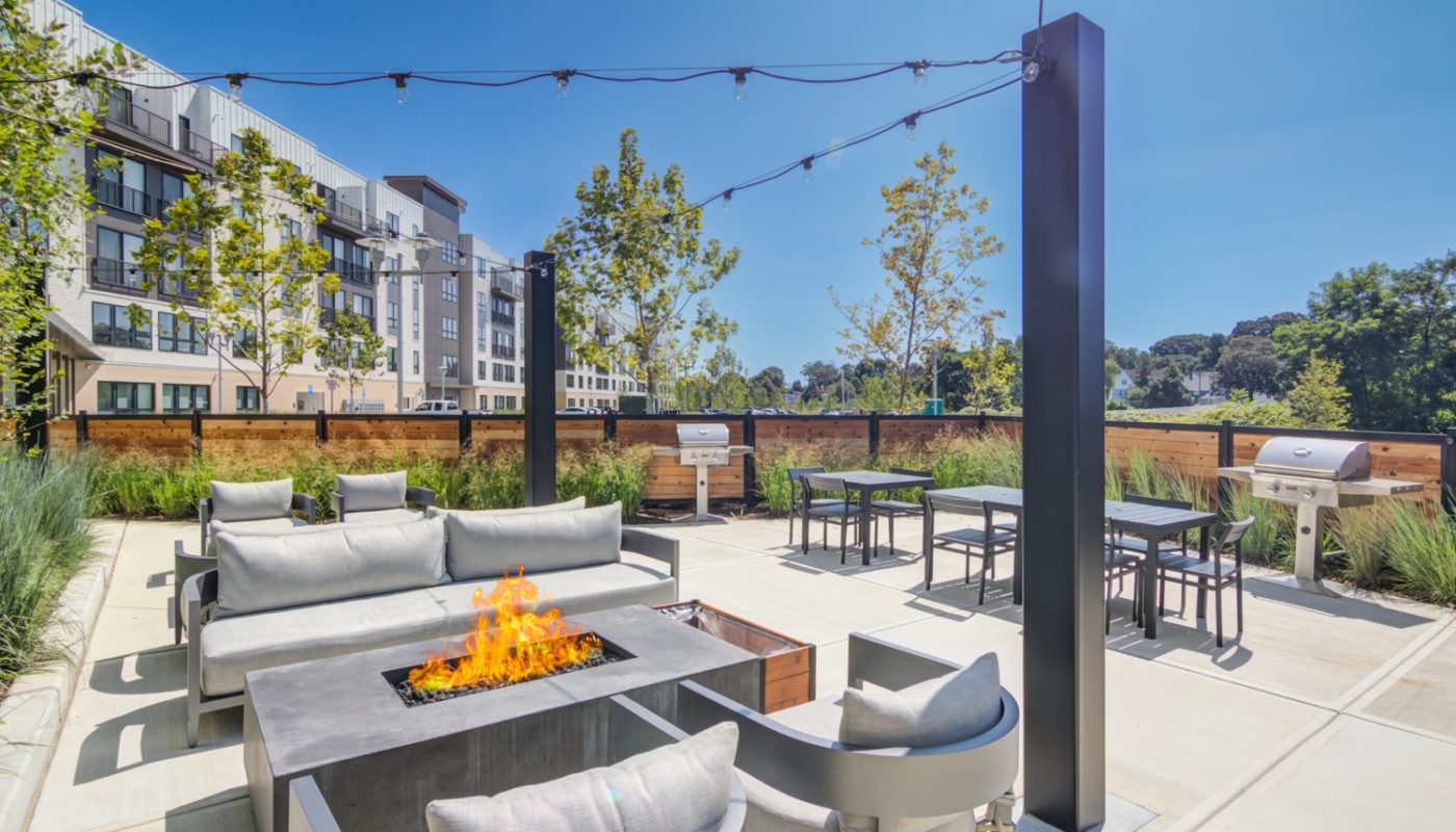 outdoor grilling area with grills and seating The Beam New London CT luxury apartments