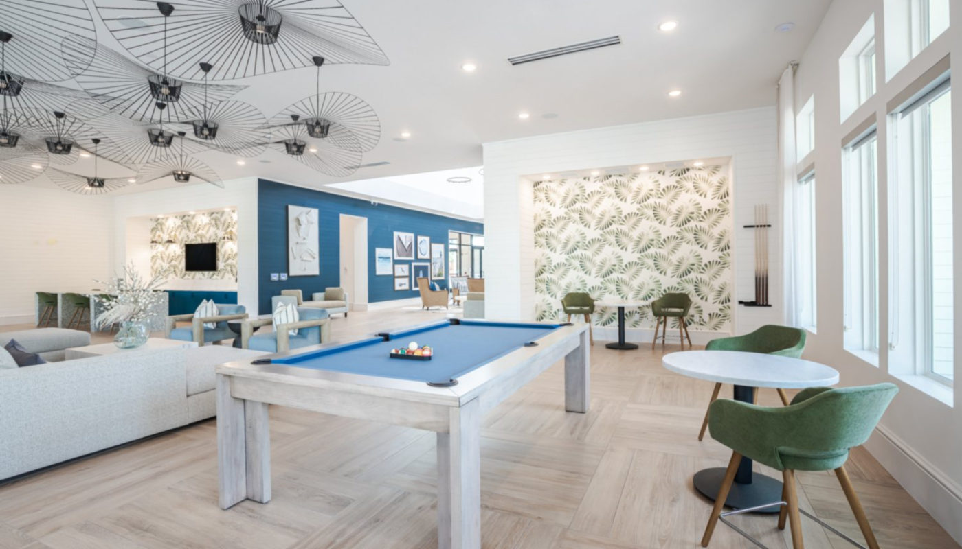 Clubroom with shuffleboard, billiards, & arcade games J Ardin Apopka FL luxury apartments for rent
