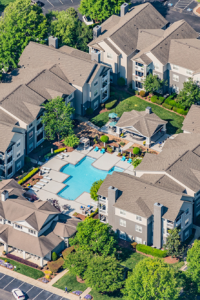 Aerial view with pool and garden style apartements at Jefferson Apartment Group