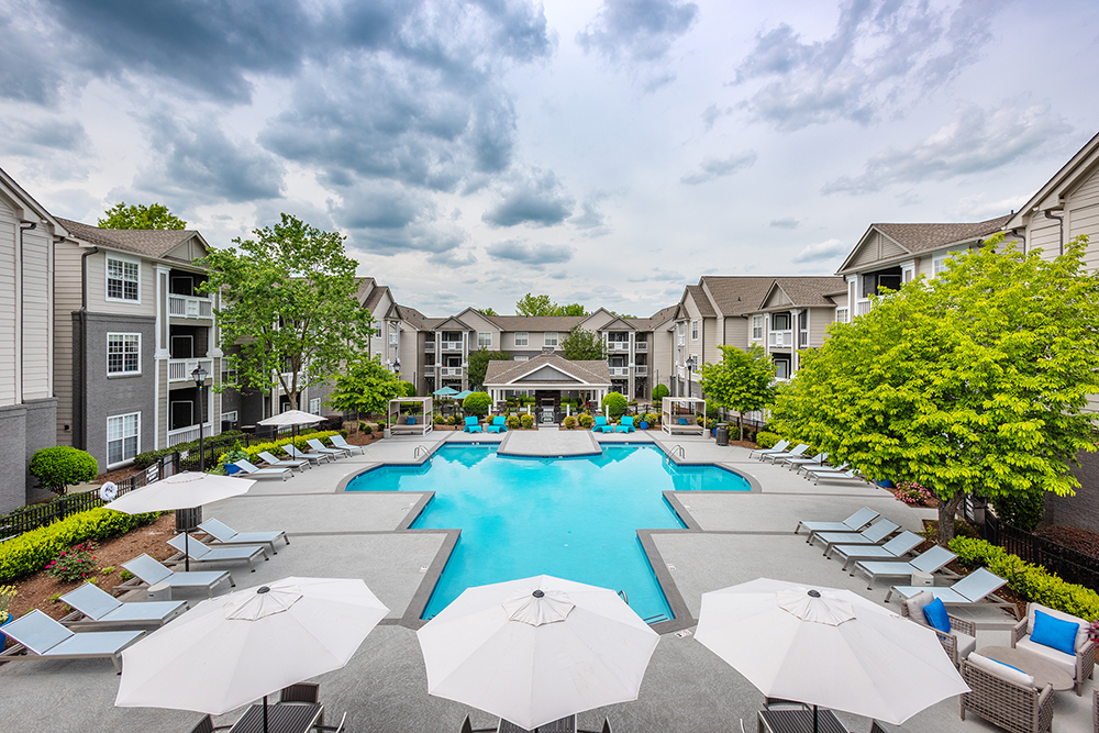 Pool area with umbrellas next to J501 Apartment building_JAG Management