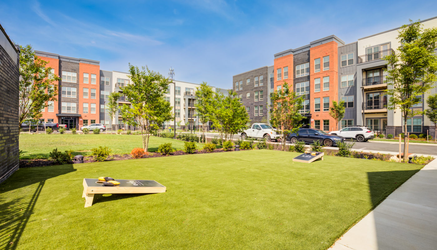 ample green space with cornhole EDE luxury apartments Frederick MD