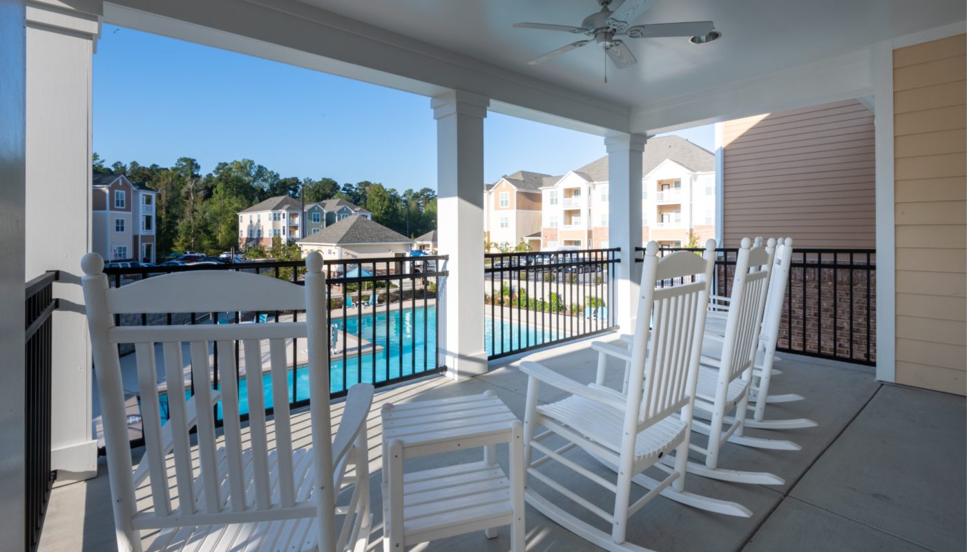 Reserve at White Oak Rocking Chairs on Porch Overlooking Pool